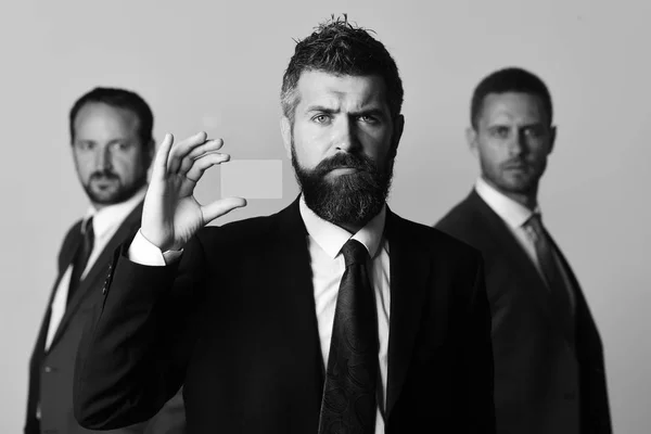 Businessmen wear smart suits and ties. Men with beard and serious faces advertise company and partnership