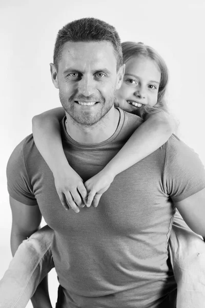 Školačka sedí na zádech tatínky. Dcera a otec objetí — Stock fotografie