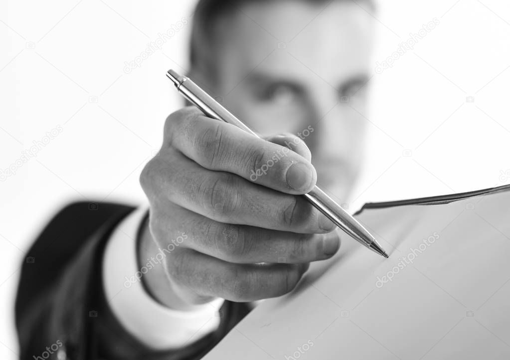 Man in suit or businessman signs document by pen.