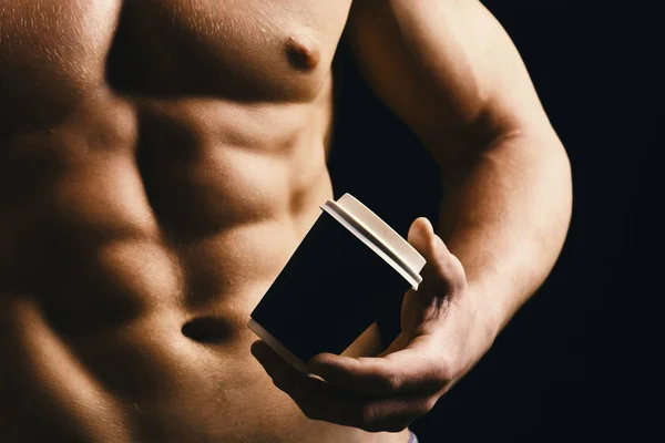 Guys abs and strong chest. Athletes body in close up, hand holding coffee cup