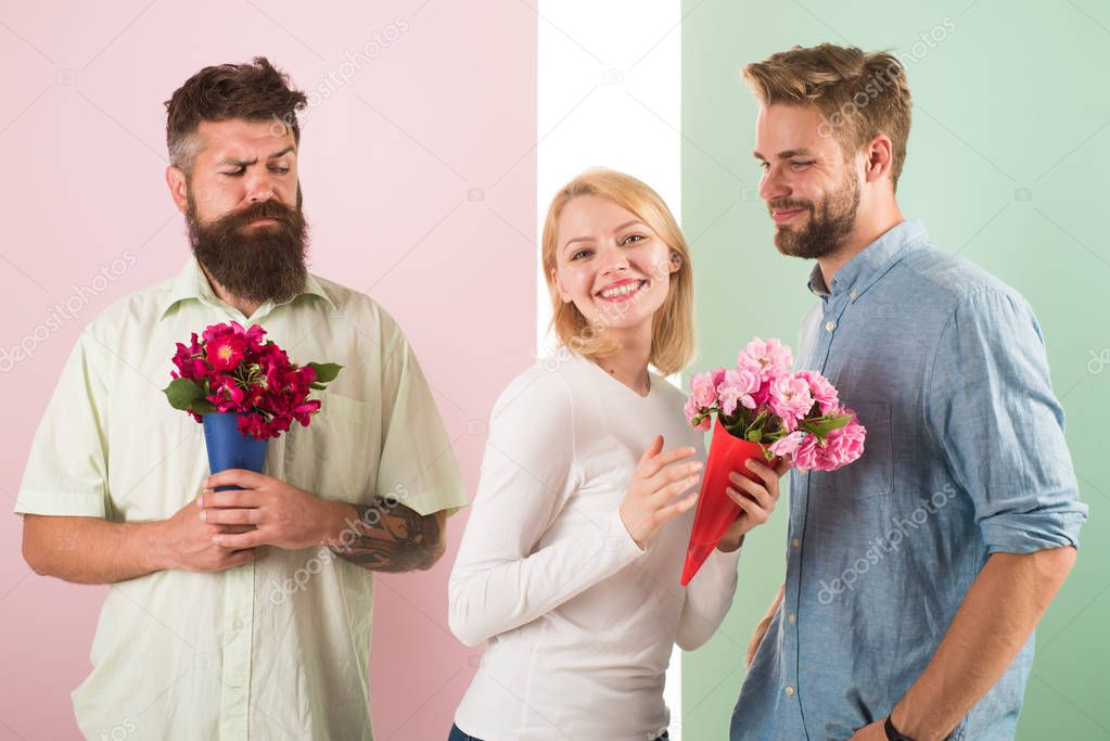 Girl smiling made her choice. Girl popular receive lot male attention. Broken heart concept. Men competitors with bouquets flowers try conquer girl. Woman happy takes bouquet flowers romantic gift
