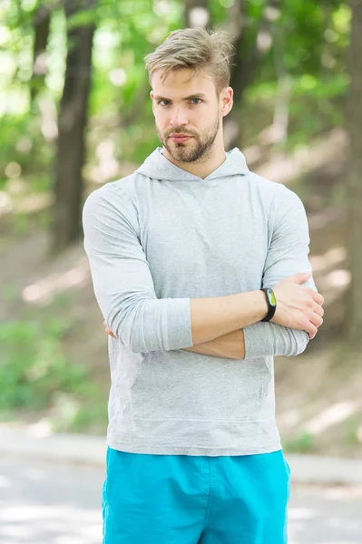 Confident sportsman. Runner workout outdoor in park. Man athlete with smart watch running outdoor, nature background. Athletic confident man trainer. Athlete guy coach watching confidently — Stock Photo, Image