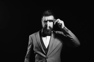 Uzun sakallı yüzü önünde jilet için bıçak tutar. Berber reklam kavramı. İşadamı ile katı yüz