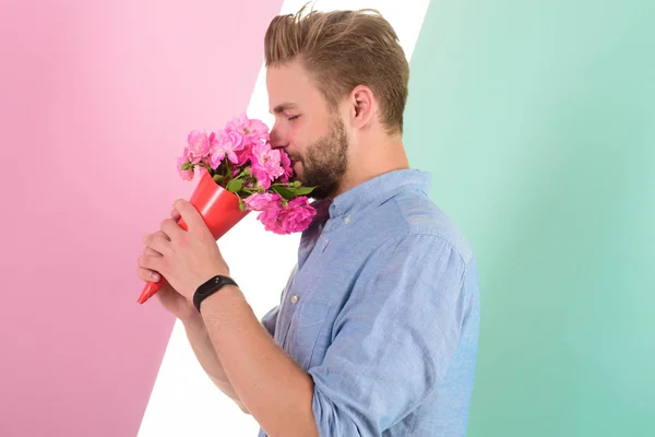 Guy bring romantic pleasant gift waiting for her. Man ready for date bring pink flowers. Boyfriend confident holds bouquet waiting for date. Best flowers for her. Macho holds bouquet as romantic gift — Stock Photo, Image