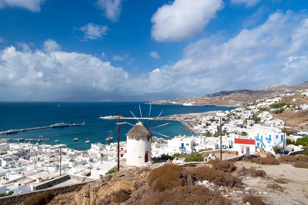 Seascape from Mykonos, Greece. Village windmill on mountain landscape by blue sea. White houses on cloudy sky with nice architecture. Wanderlust and travel. Summer vacation on mediterranean island — Stock Photo, Image