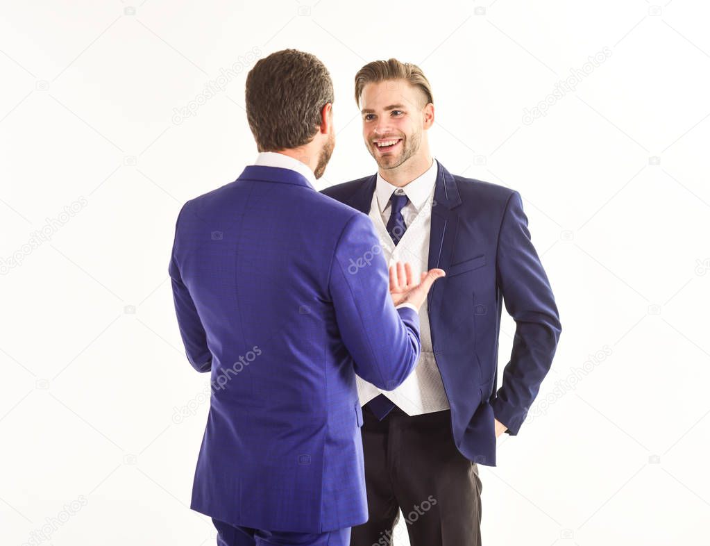 happy men in jacket discussing business , partnership and friend