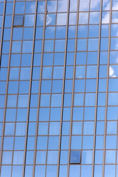 Fundo de fachada de vidro com reflexão céu azul. Arquitetura e estrutura modernas. Construção e design. Propriedade comercial ou imobiliária. Sucesso e conceito futuro — Fotografia de Stock