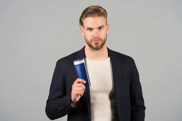 Confident in hair care product. Man stylish hairstyle holds bottle hygienic product grey background. Switch matte products if thinning. Men hair thins out. Matte products make hair appear thicker
