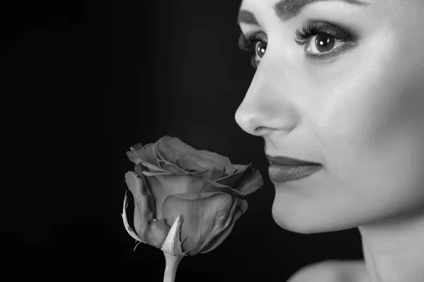 Woman sniff rose, black background copy space. Lady with makeup enjoy flower close up. What kind of flowers do women like. What every man should know about giving flowers. I am so pleased.