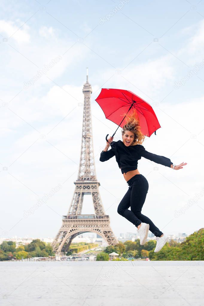 Woman jump with fashion umbrella. Happy woman travel in paris, france. Parisian isolated on white background. Girl with beauty look at eiffel tower. Travelling and wanderlust. Enjoy summer vacation