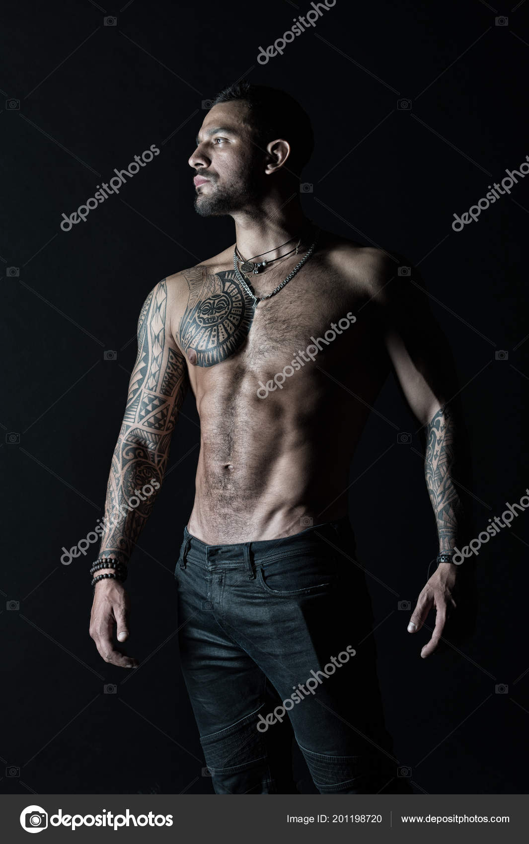 Tattooed man show sexy muscular torso. Sportsman with six pack and ab. Bodybuilder with biceps and triceps. Fashion model with tattoo in jeans. Bodycare with fitness and sport in vintage filter Stock Tattooed man show sexy muscular torso. Sportsman with six pack and ab. Bodybuilder with biceps and triceps. Fashion model with tattoo in jeans. Bodycare with fitness and sport in vintage filter Stock