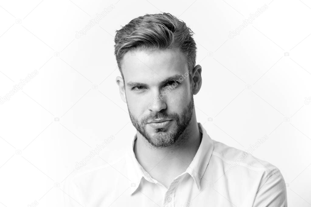 Man with serious look. Bearded macho with beard on unshaven face isolated on white background. Bearded and handsome. Hair and barber salon. Skin care and grooming, black and white