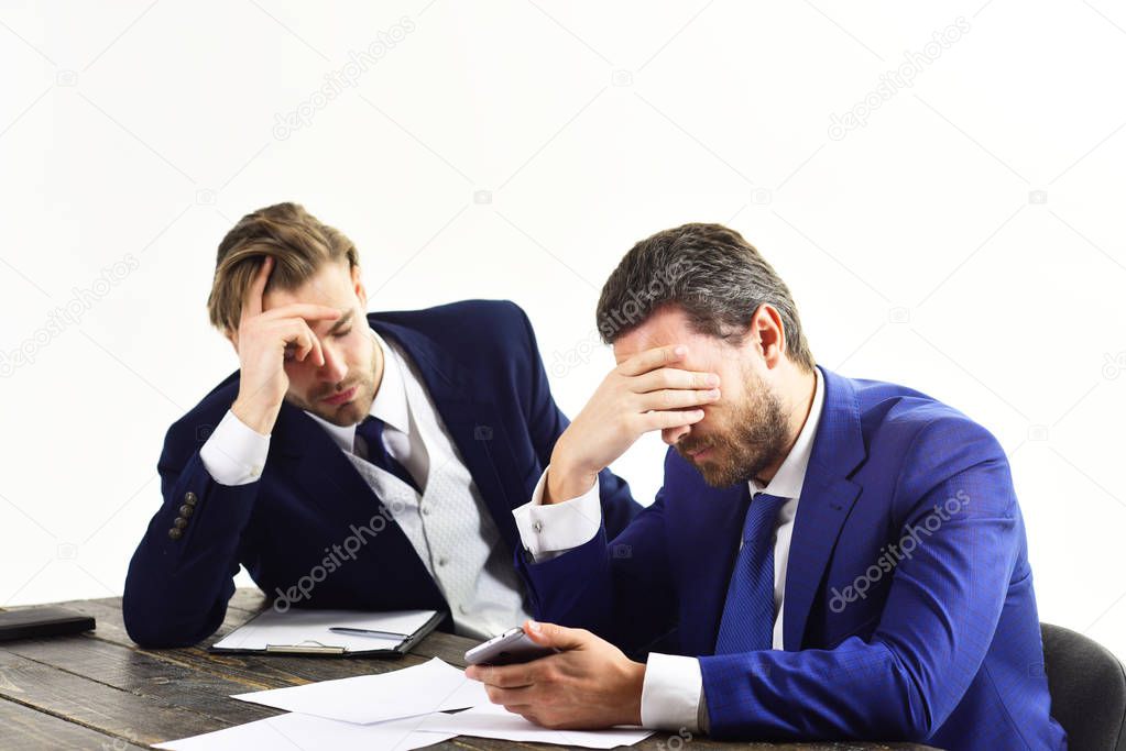 Employees in formal suits look stressed and depressed.