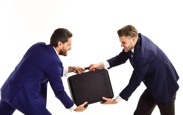 Businessmen or men in classic suits pulling black briefcase. — Stock Photo, Image