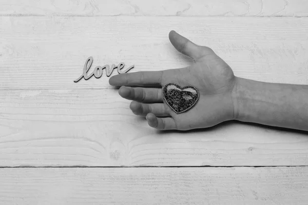 heart on man hand and word love