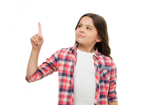 Wait a minute. Girl pointing upwards index finger. Child warning or asks for attention. Girl casual outfit thoughtful face pointing direction. Kid with index finger pointing upwards direction