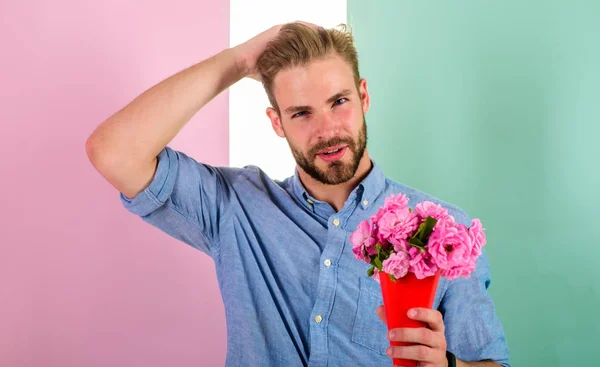 Macho holds bouquet as romantic gift. Guy bring romantic pleasant gift waiting for her. Man ready for date bring pink flowers. Boyfriend confident holds bouquet waiting for date. Best flowers for her