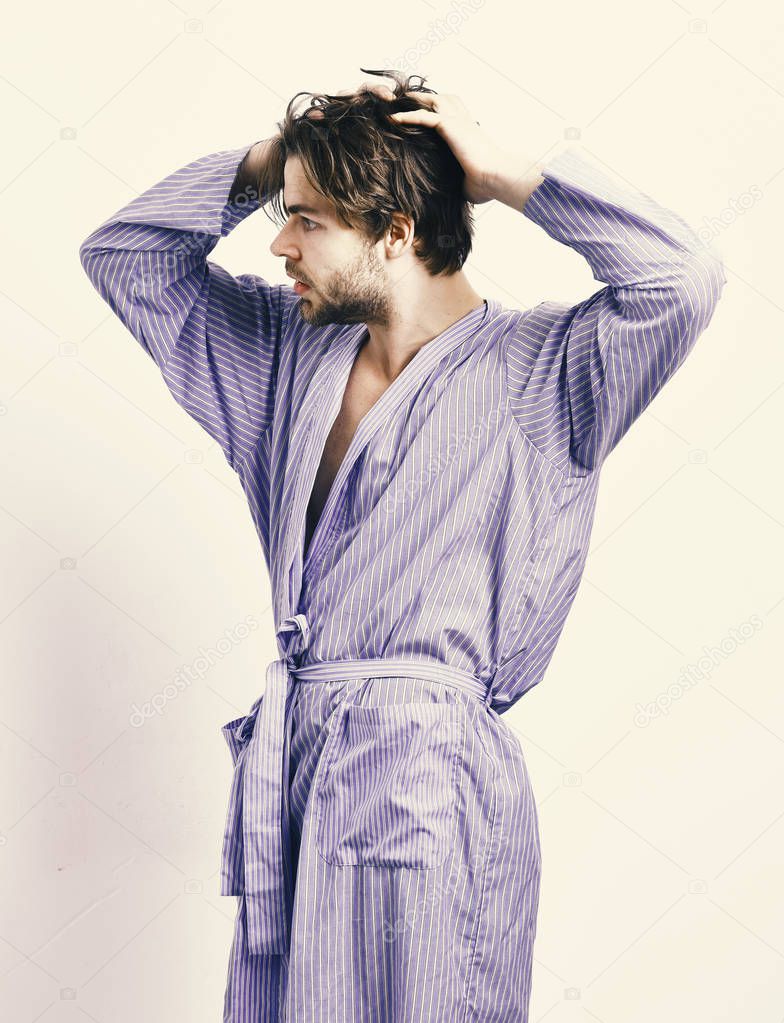 Bearded macho in blue bathrobe or leisure wear.