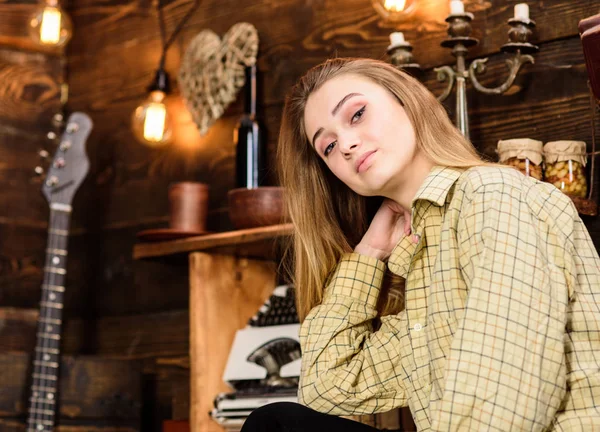 Girl tomboy spend time in house of gamekeeper. Tomboy concept. Lady on dreamy face in plaid clothes looks cute and casual. Girl in casual outfit in wooden vintage interior — Stock Photo, Image