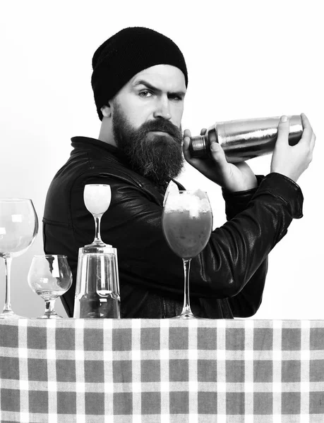 Brutal caucasian hipster holding alcoholic beverage or fresh cocktail