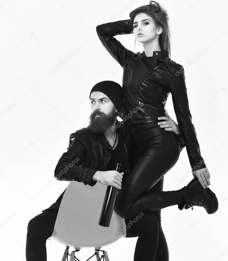 Couple in love with curious faces on white background. Rock lovers drink spirits. Street life style concept.