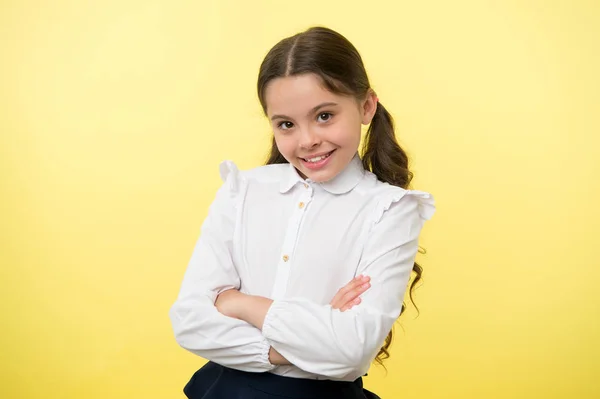 Happy girl keep arms crossed on yellow background. Little child with cute smile and brunette hair. Casual look and fashion. Beauty salon. Smile is always in fashion — Stock Photo, Image