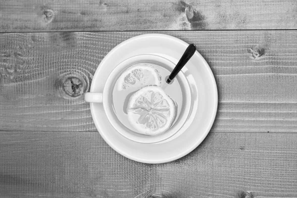 English tea time concept. Tea cup on saucer on wooden background, top view