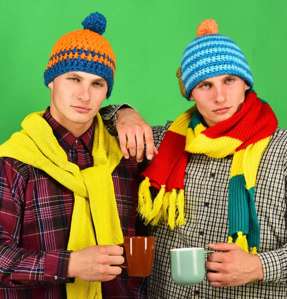 Twins with serious faces hold cups. Autumn season and friendship — Stock Photo, Image