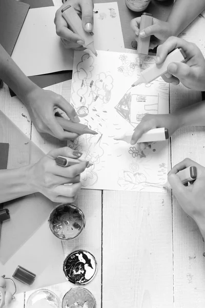 Markers in male and female hands draw house and rain — Stock Photo, Image