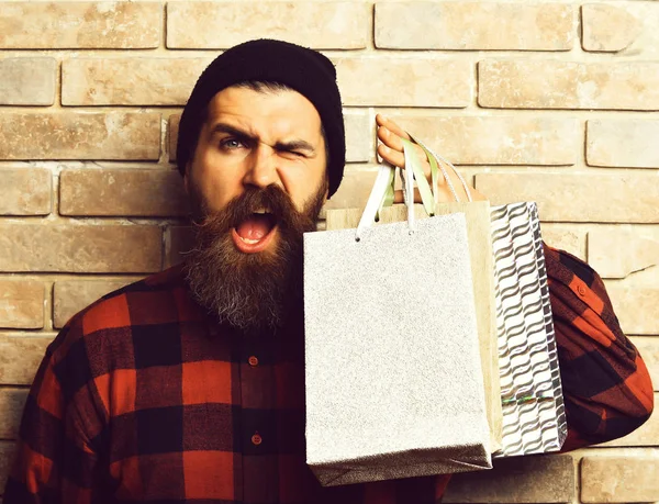 Barbudo brutal caucasiano hipster com bigode segurando pacotes de compras — Fotografia de Stock