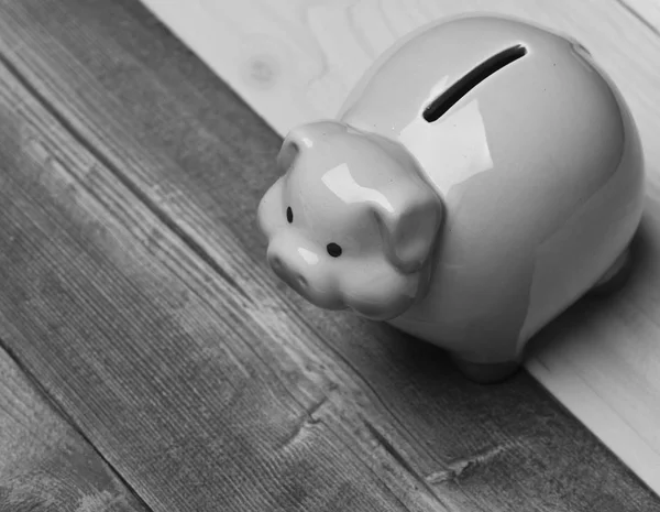 Piggy bank in pink color on colorful wooden background. — Stock Photo, Image