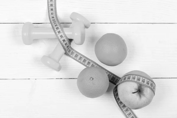 Sport training concept, dumbbells weight with fruits on white vintage — Stock Photo, Image