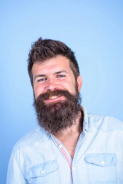 Man happy bearded hipster with mustache smiling face blue background. Healthy beard is result of healthy diet. Regular trimming help maintain shape. Wash and shampoo your beard regularly