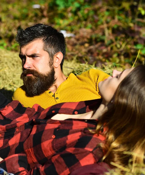 Girl and bearded guy or happy lovers lie on grass — Stock Photo, Image