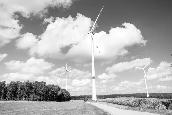 Turbines on field on cloudy blue sky — Stock Photo, Image