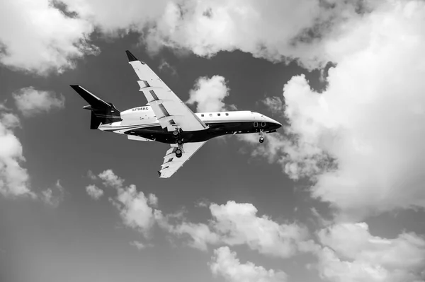 Philipsburg, Sint Maarten - February 13, 2016: aircraft fly on cloudy blue sky. Plane in clouds. Jet on flight on sunny day. Travel by air transport, aviation. Wanderlust, vacation and trip — Stock Photo, Image