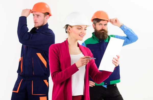 Female boss concept. Woman in hard hat with busy face