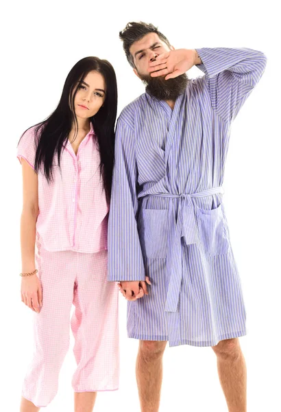 Couple, family on sleepy faces, yawning in clothes for sleep looks sleepy in morning. Insomnia concept. Couple in love in pajama, bathrobe. Couple hold hands together, isolated on white background