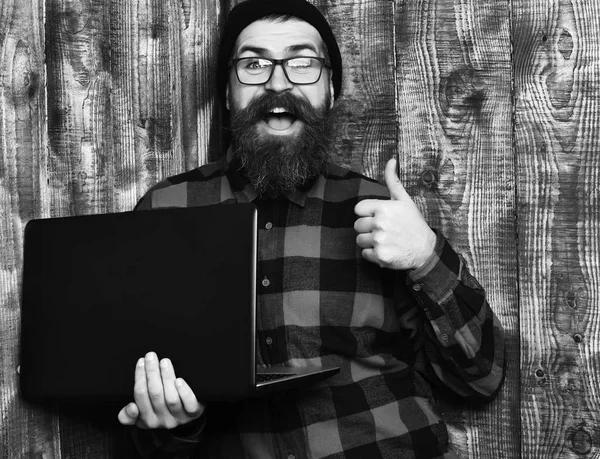 Kaba sakallı, beyaz tenli hippi dizüstü bilgisayar tutuyor. — Stok fotoğraf
