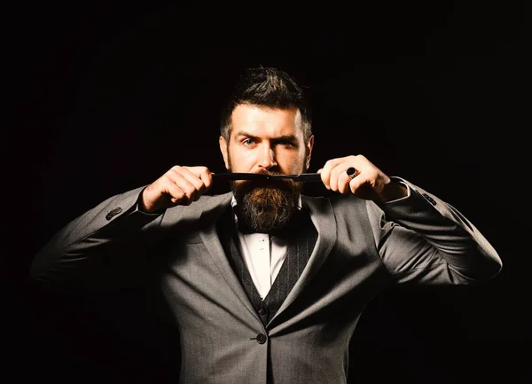 Macho in formal suit shaves beard. Barbershop advertising