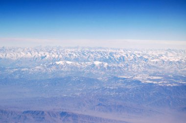 Mavi gökyüzü, havadan görünümü üzerinde Dünya gezegeni. Dağ manzarası. Dünya çapında seyahat. Çevre koruma ve ekoloji. Dünyayı kurtarmak