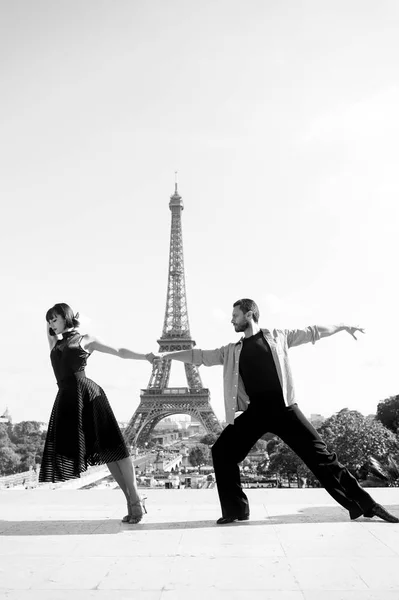dance couple in front of eifel tower in paris, france. beatuiful ballroom dance couple in dance pose near eifel tower. romantic travel concept