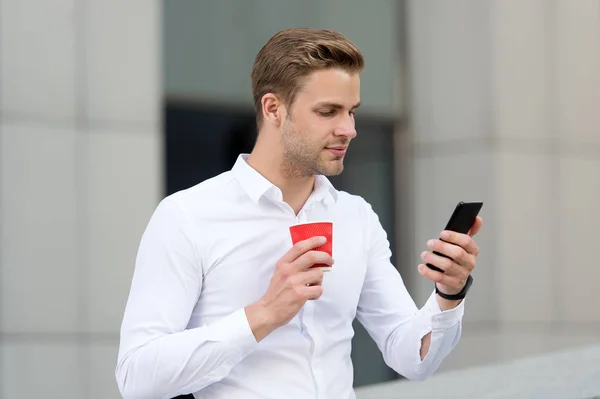 Check emails. Man drinks coffee checking emails in morning urban background. Strat great day. Businessman relaxing with coffee morning time. Guy handsome attractive businessman needs energy charge