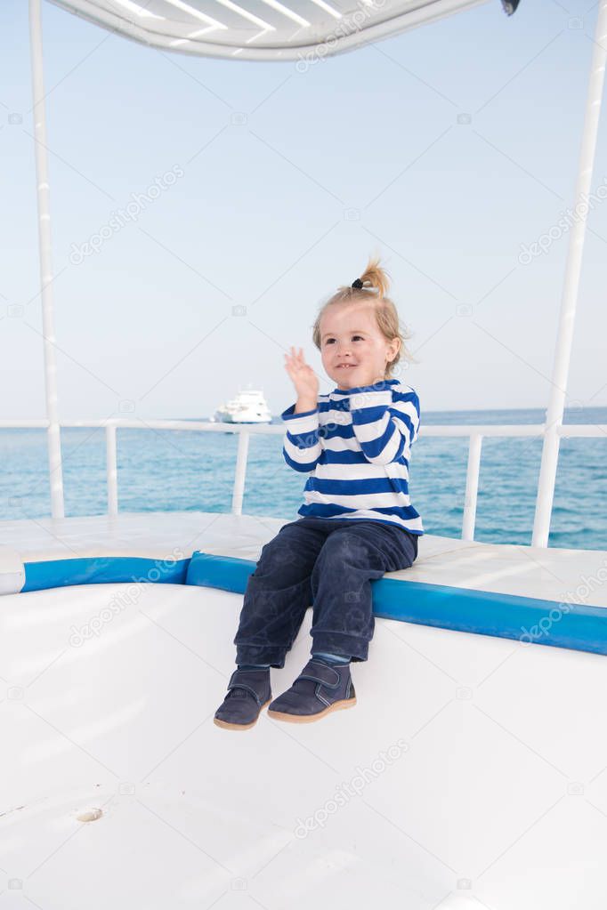 Best cruises for kids. Kid boy toddler travelling sea cruise. Child in striped shirt looks like young sailor. Child enjoy vacation on cruise ship. Family vacation on cruise ship all inclusive tour