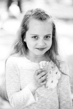 Güneşli açık havada dondurma külahlı mutlu çocuk. Küçük kız dondurma yemekten hoşlanıyor. Uzun sarı saçlı çocuk gülüşü. Yiyecek, atıştırmalık ve tatlı. Yaz tatili ve dinlenme