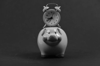 Piggy bank with retro alarm clock. Saving time concept clipart