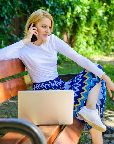 Girl dreamy takes advantage of online shopping. Girl sit bench with notebook call phone. Save your time with shopping online. Shopping online. Woman laptop in park enjoy green nature and fresh air