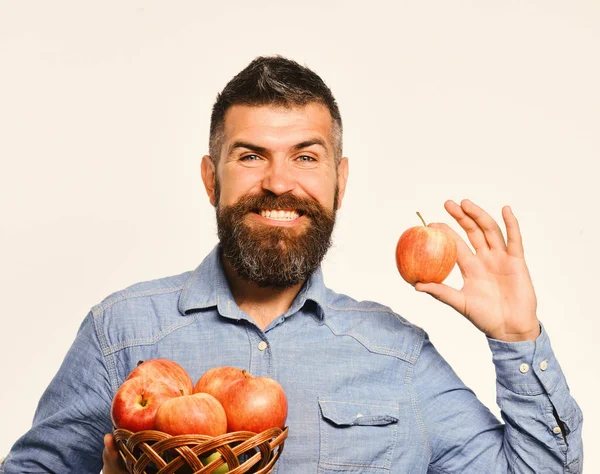 Guy presents homegrown harvest. Farming and autumn crops concept. Man with beard
