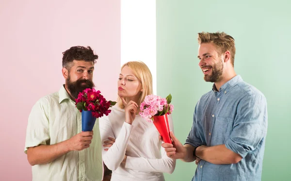 Men competitors with bouquets flowers try conquer girl. Girl likes to be in middle attention. Girl popular receive lot men attention. Love triangle. Woman thoughtful has opportunity choose partner — Stock Photo, Image