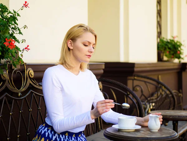 Traditional tea with milk. Woman elegant calm face have drink cafe terrace outdoors. Girl drink tea with milk as aristocratic tradition. Mug of good tea with milk in morning gives me energy charge